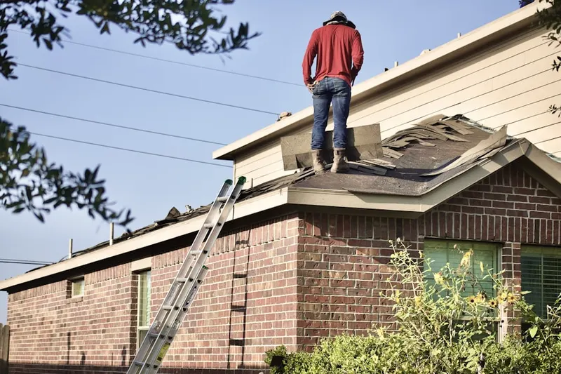 Professional roofer working on a residential roof in Harper's Landing